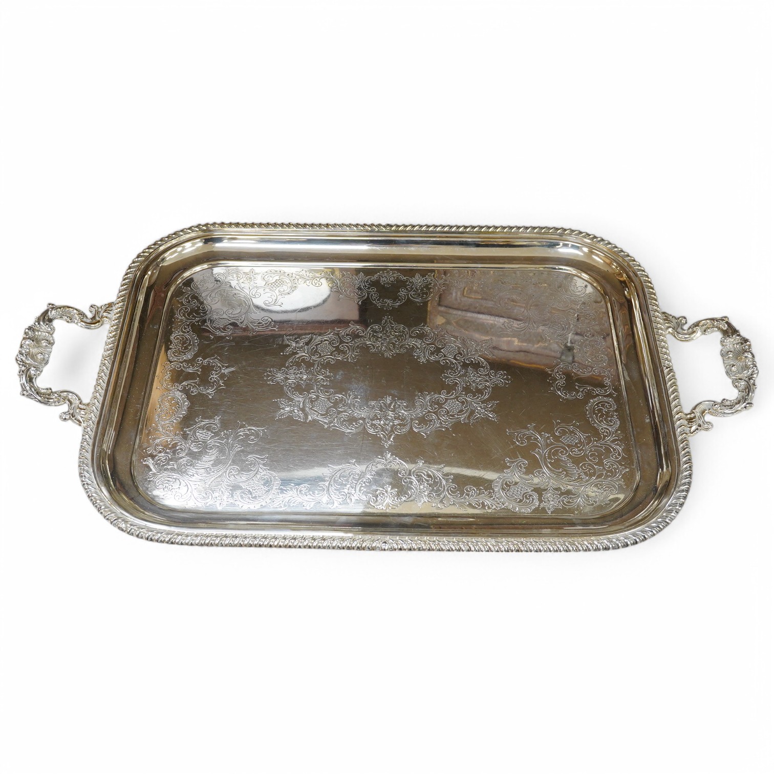 A two handled silver plated tea tray, 63.5cm wide. Condition - some scratches.